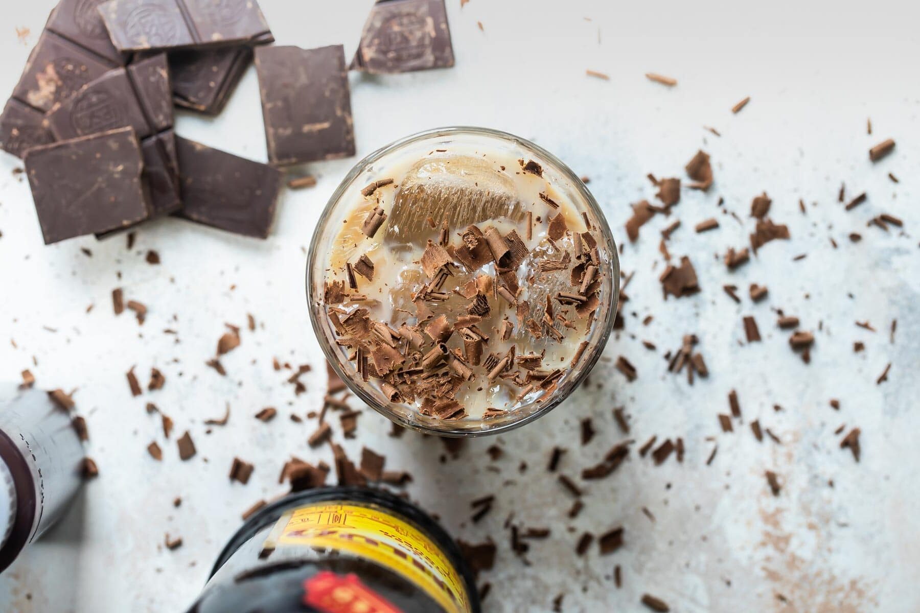 A mudslide cocktail with chocolate in the background.