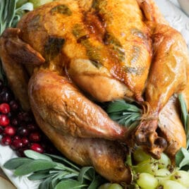 A platter of roast turkey garnished with grapes.