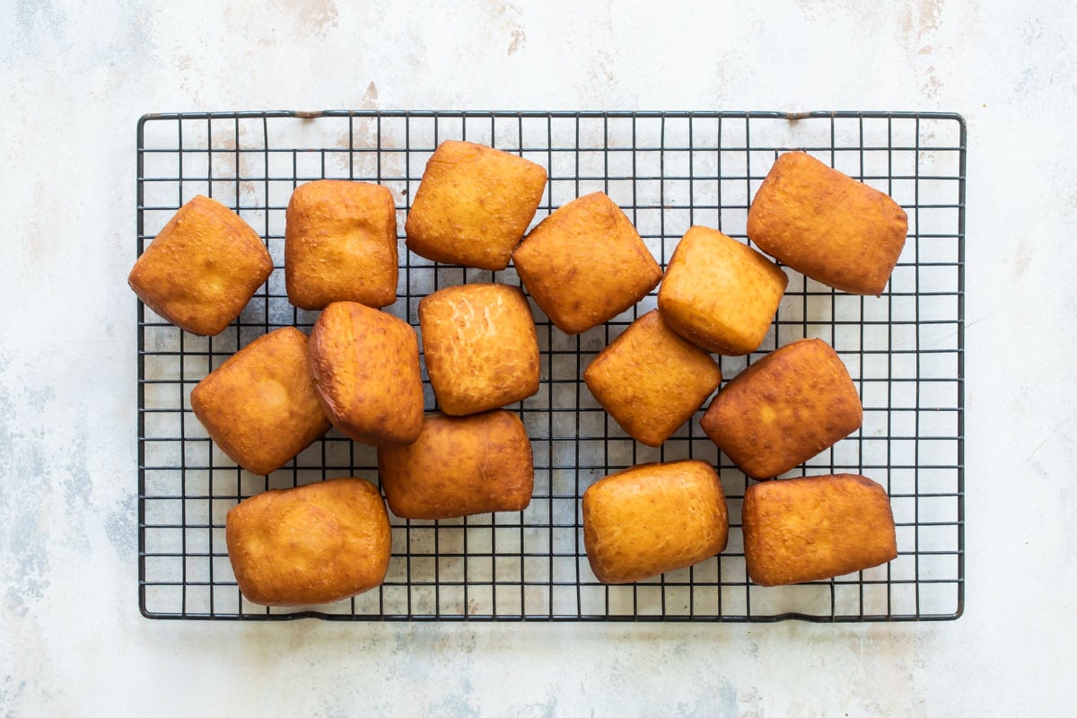 Beignets on a cooling rack.