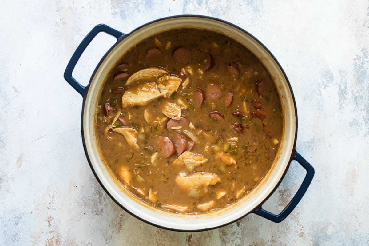 Chicken gumbo being cooked in a Dutch oven.
