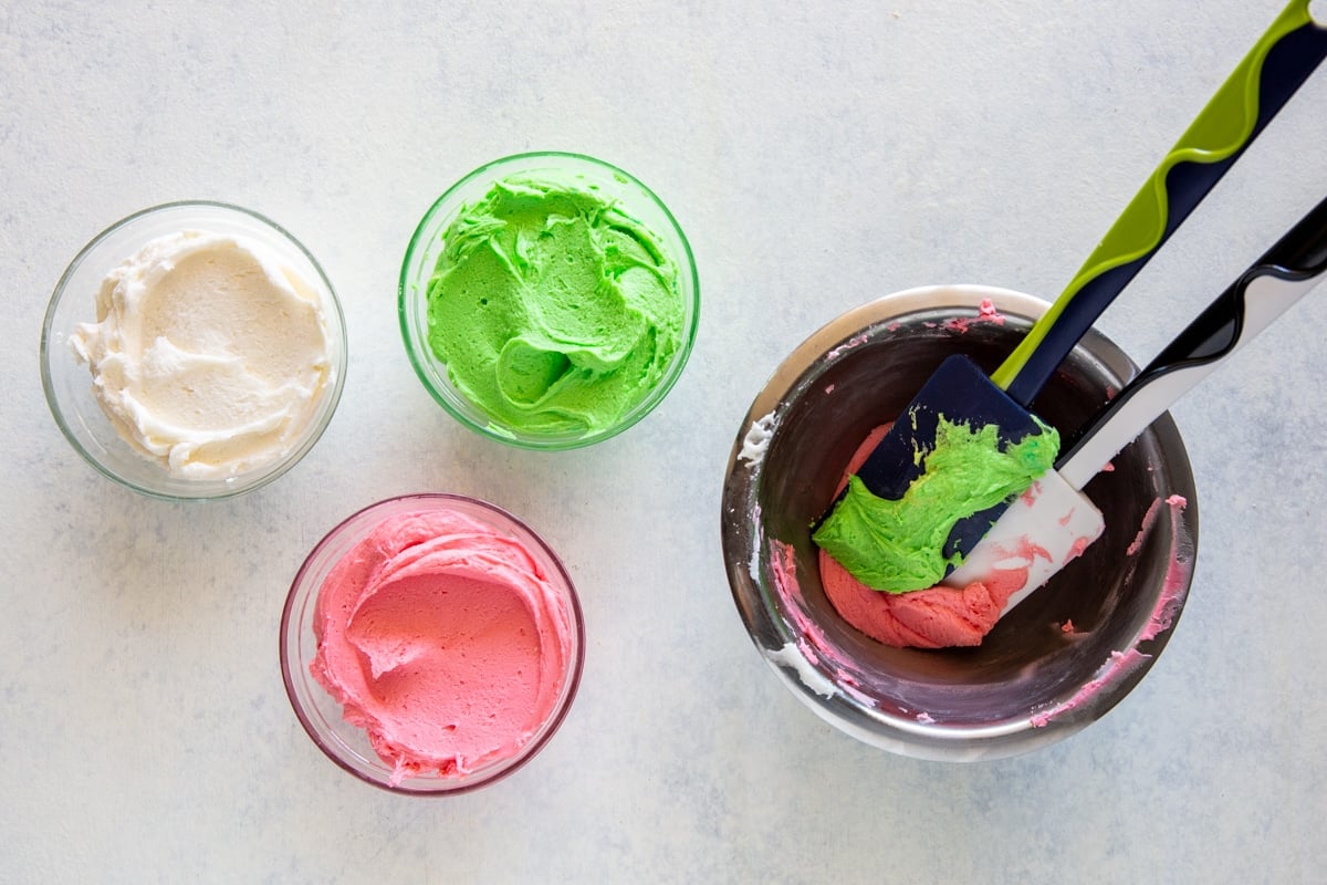 White, green, and pink frosting for sugar cookies.