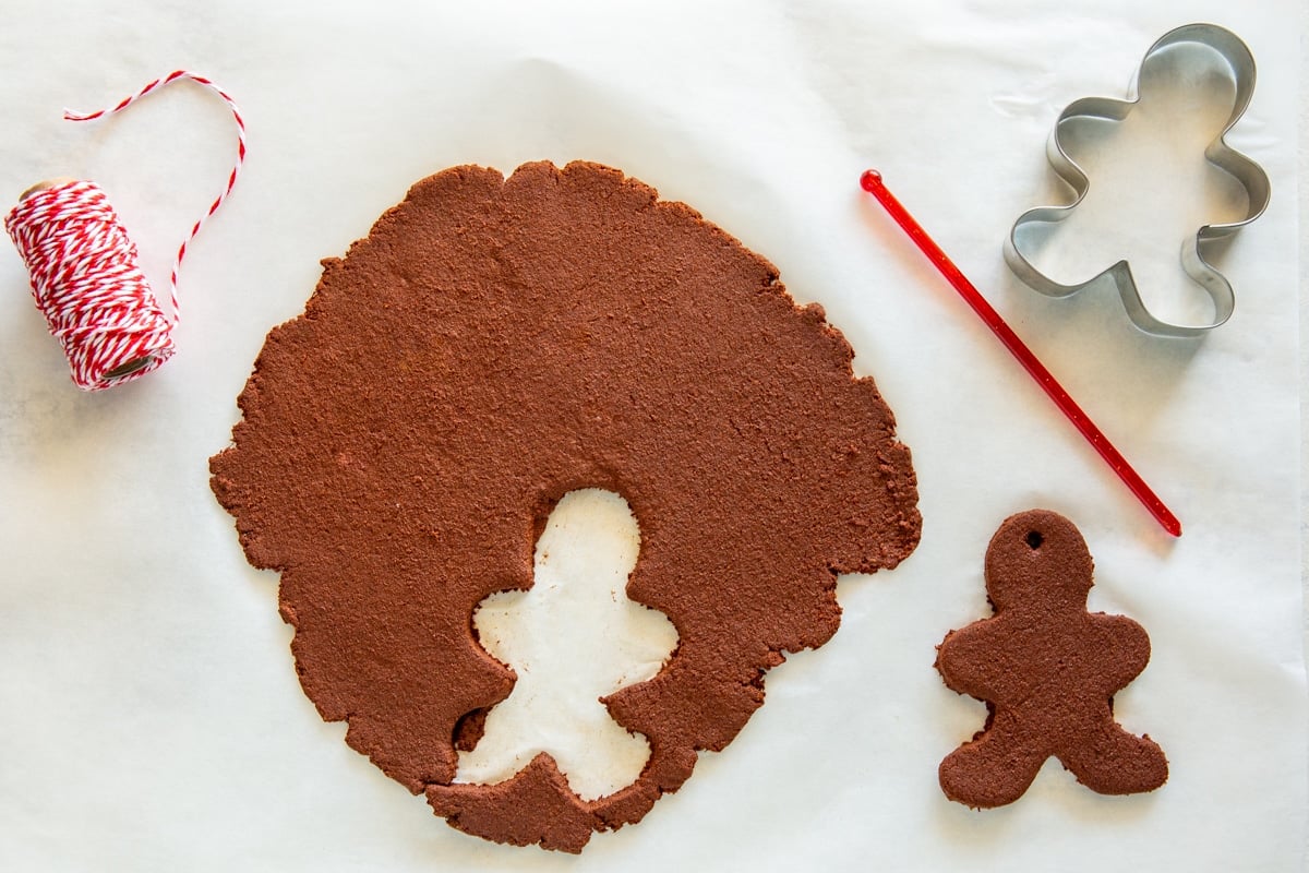 A Gingerbread man shaped cinnamon ornament cut out of cinnamon dough.