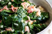 A bowl with collard greens in it.