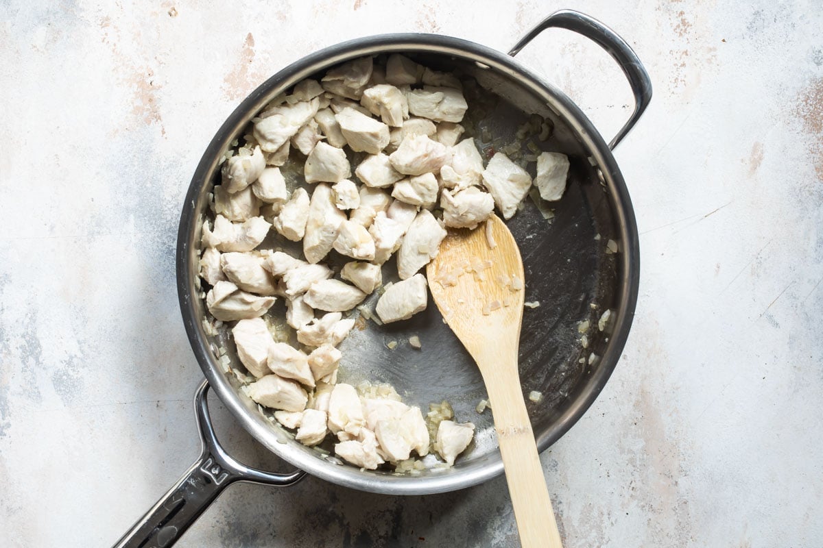 Chicken cooking in a skillet.