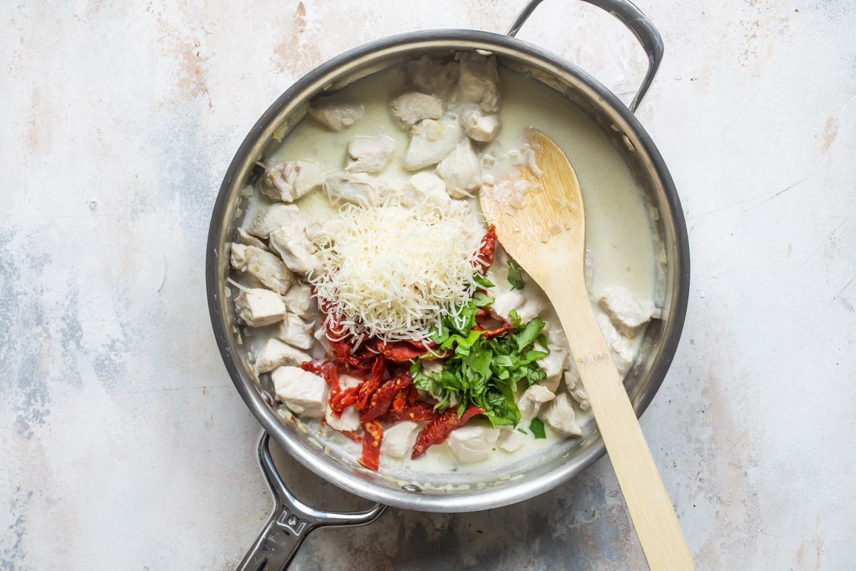 A skillet of creamy chicken pasta.