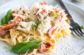 Two plates of creamy chicken pasta.
