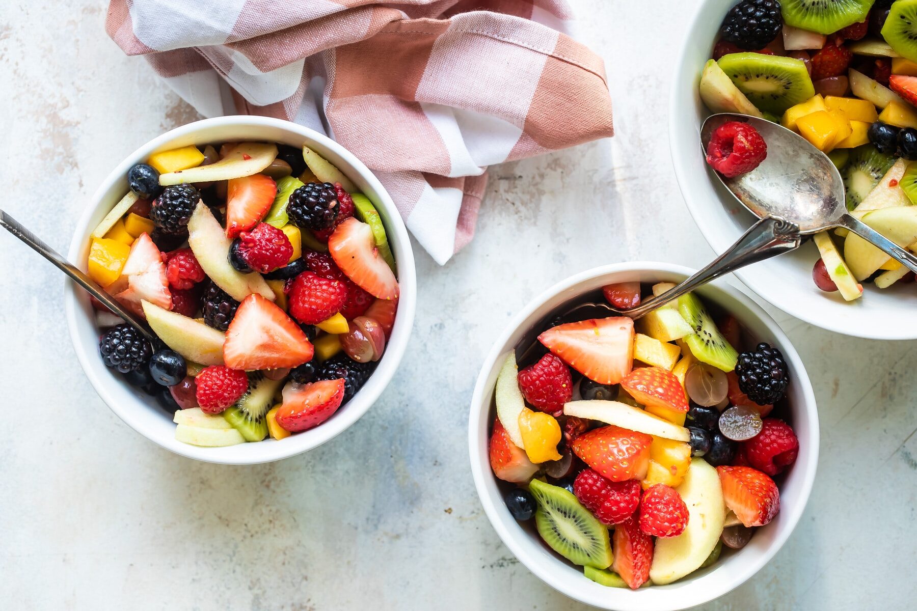 Fruit salad in three bowls.