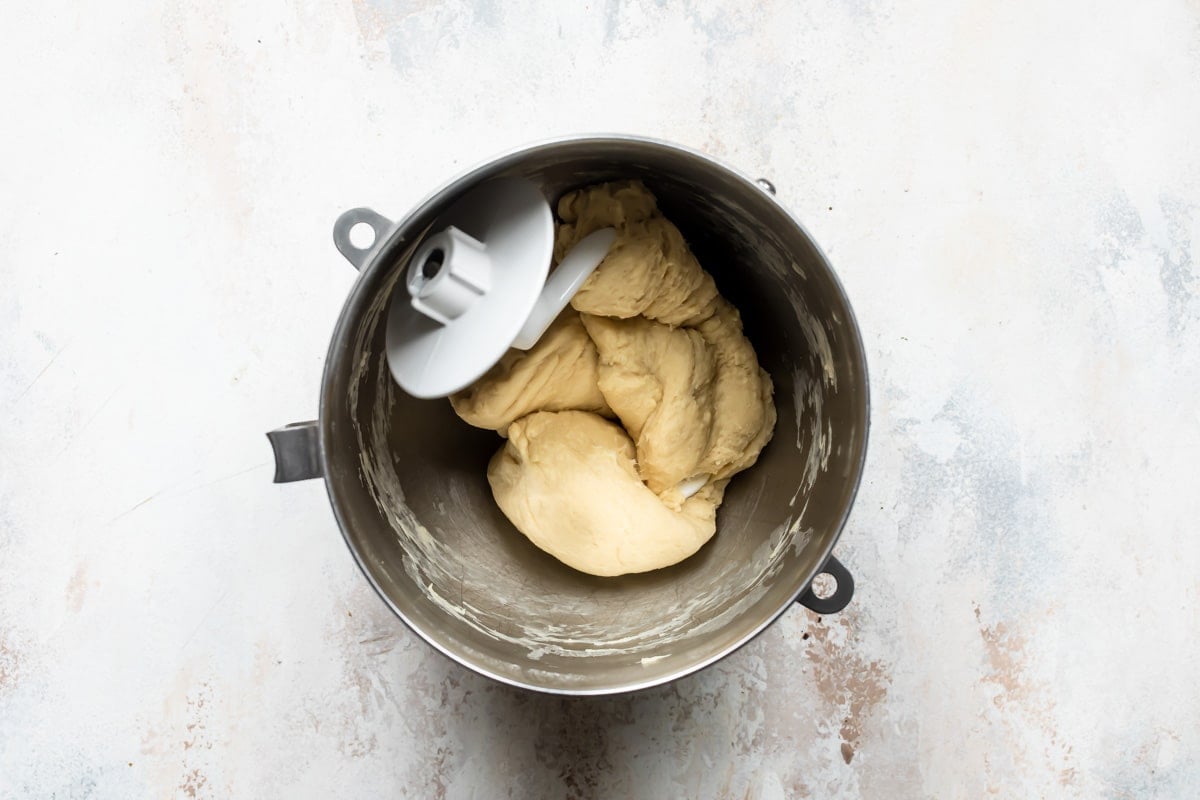 King cake dough in a silver mixing bowl.