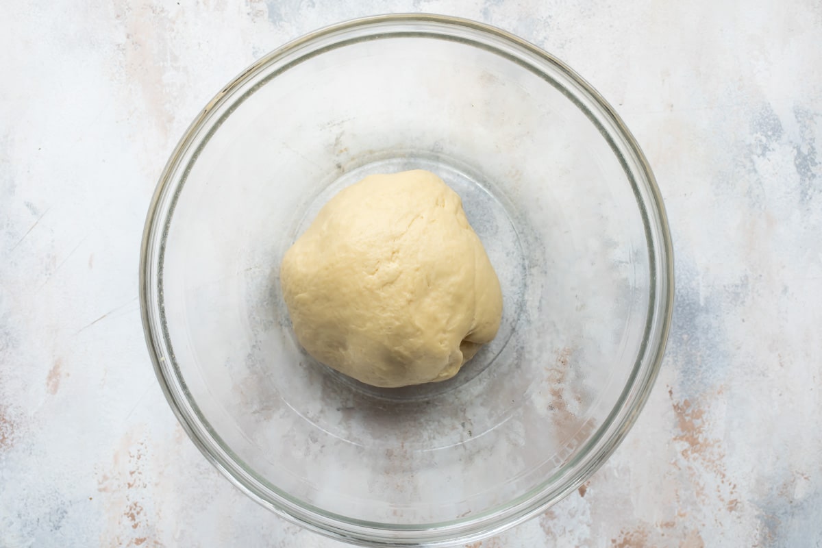 King cake dough in a clear bowl.