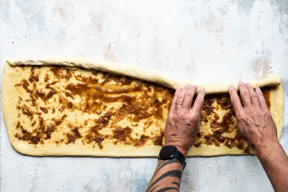 Someone rolling king cake dough.