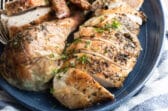 Make ahead roasted turkey on a blue platter.