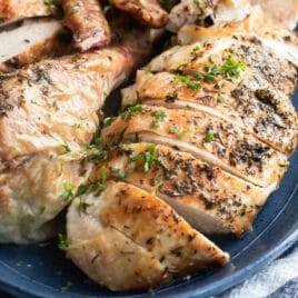 Make ahead roasted turkey on a blue platter.