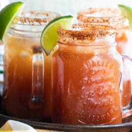 Three Micheladas on a metal tray.