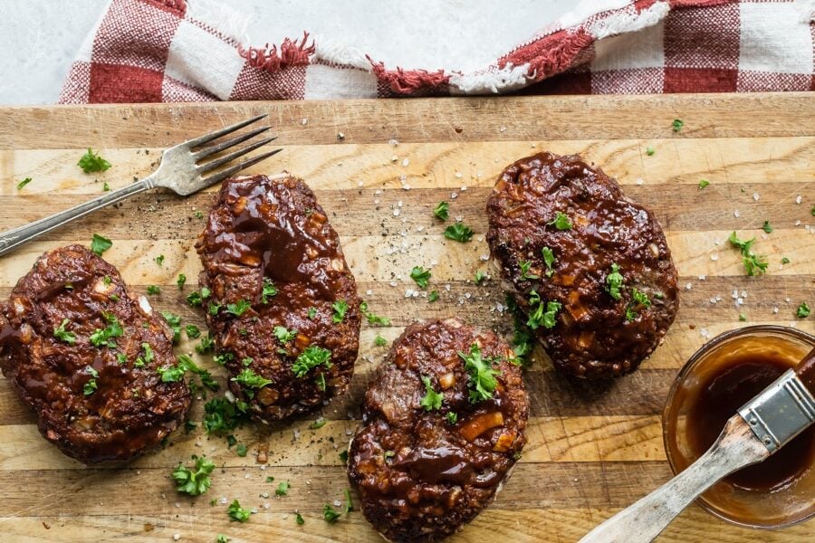 This mini meatloaf recipe with a shiny balsamic glaze is sure to please. I love the idea of mini meatloaves because they are pre-portioned, making them easier to serve. The meatloaf mixture is simple and light, with the use of panko breadcrumbs and a few staple ingredients.