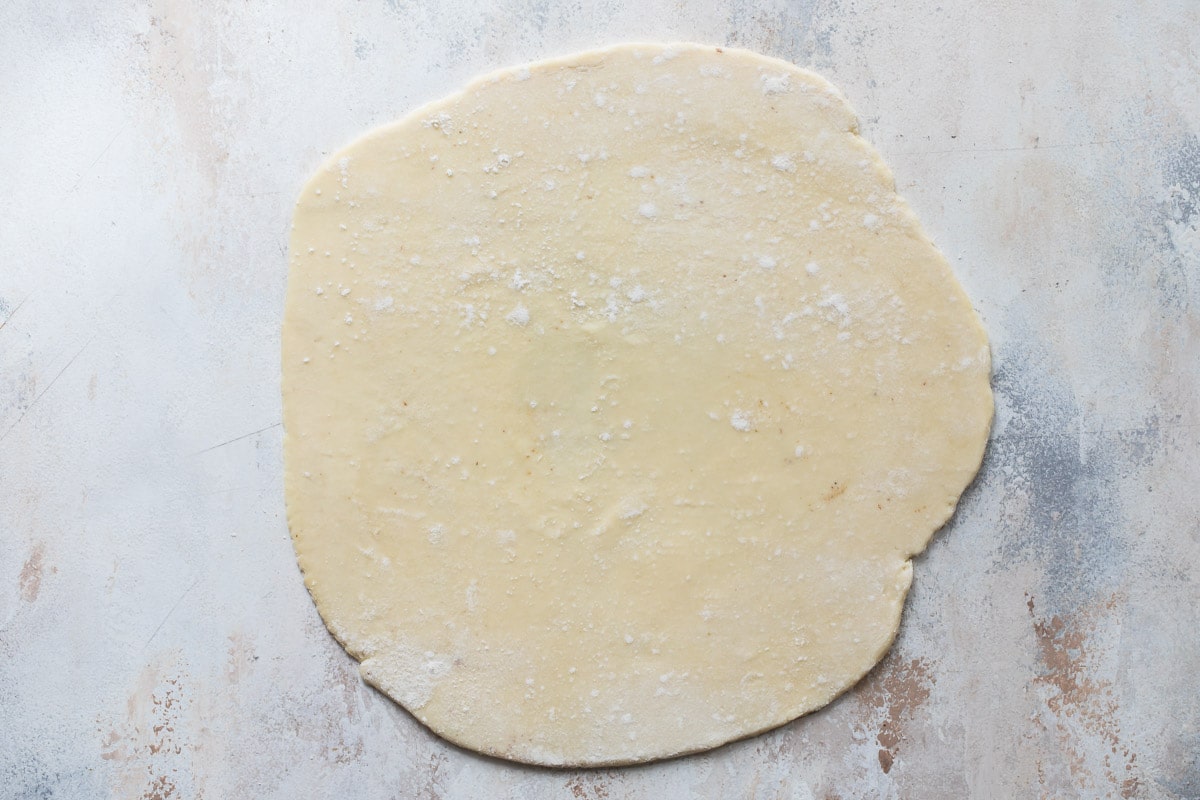 Rugelach dough on a countertop before being sliced.