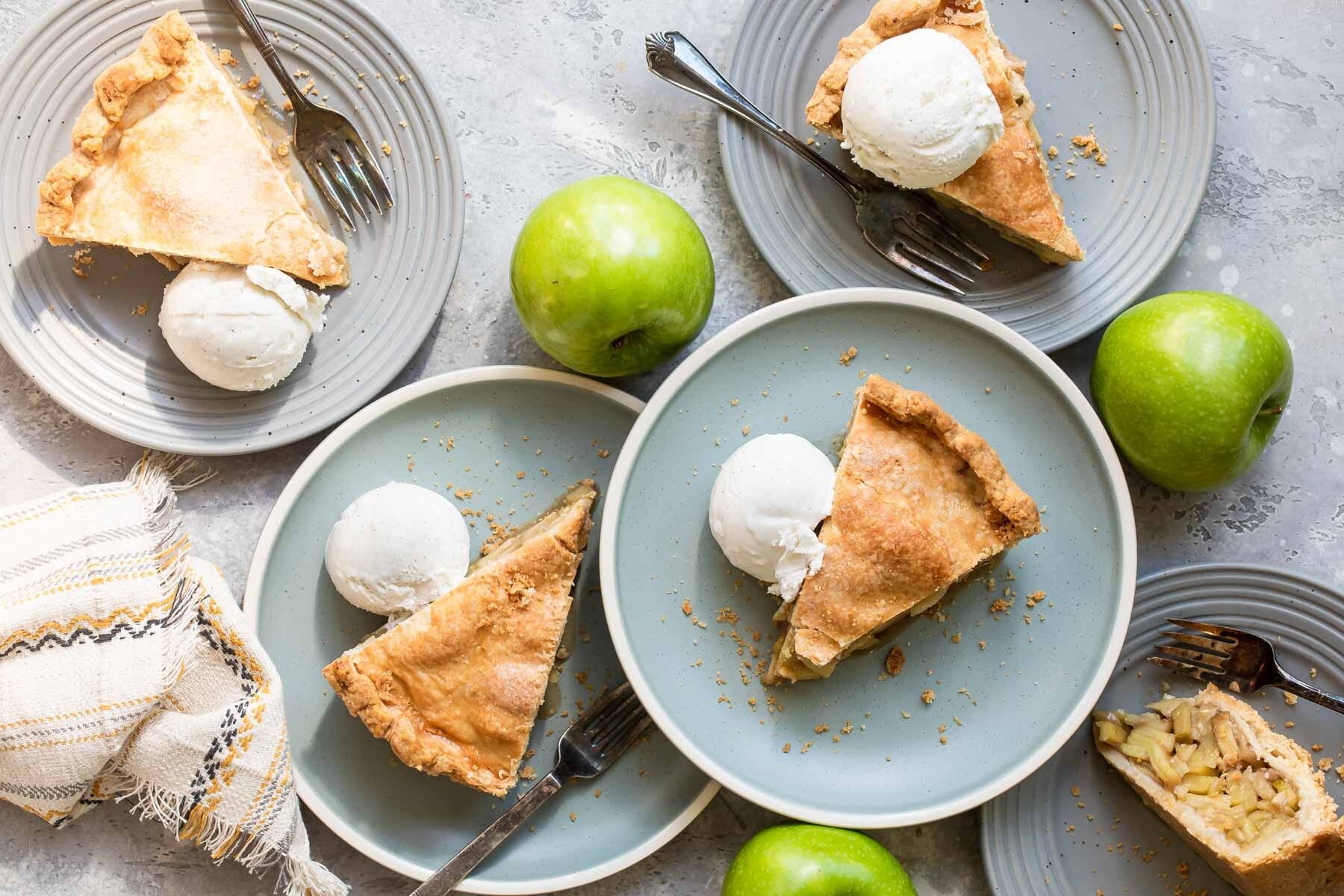 Slices of apple pie with vanilla ice cream.