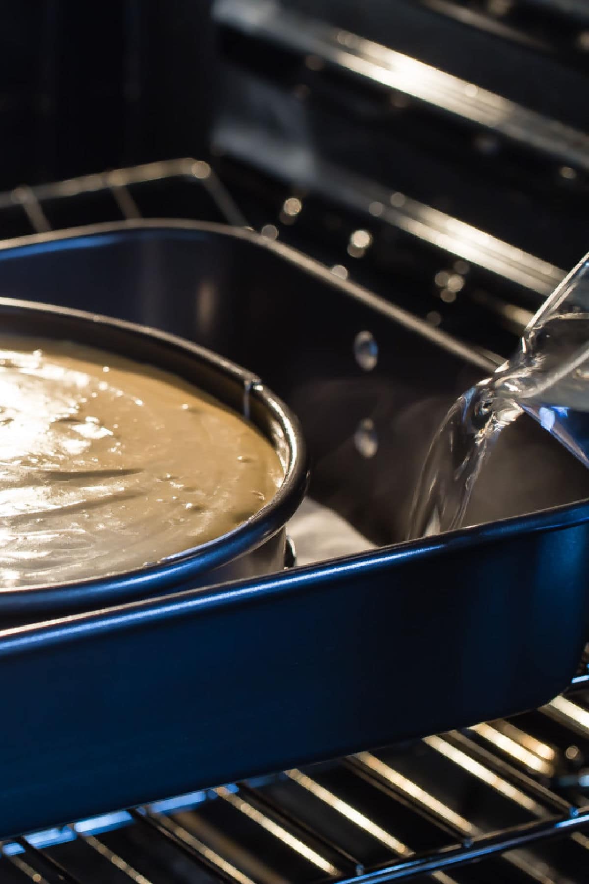 Water being poured into a pan to make a water bath for a cheesecake.