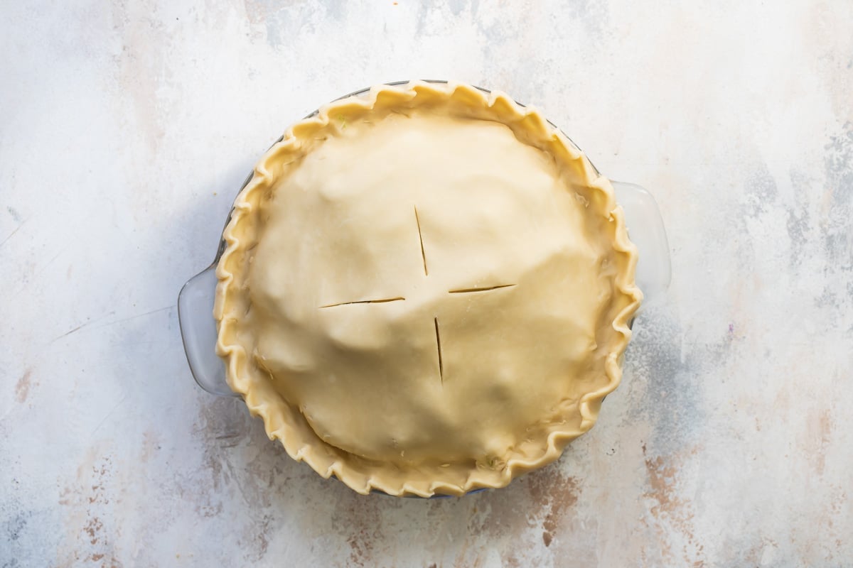 An unbaked, unsliced apple pie.