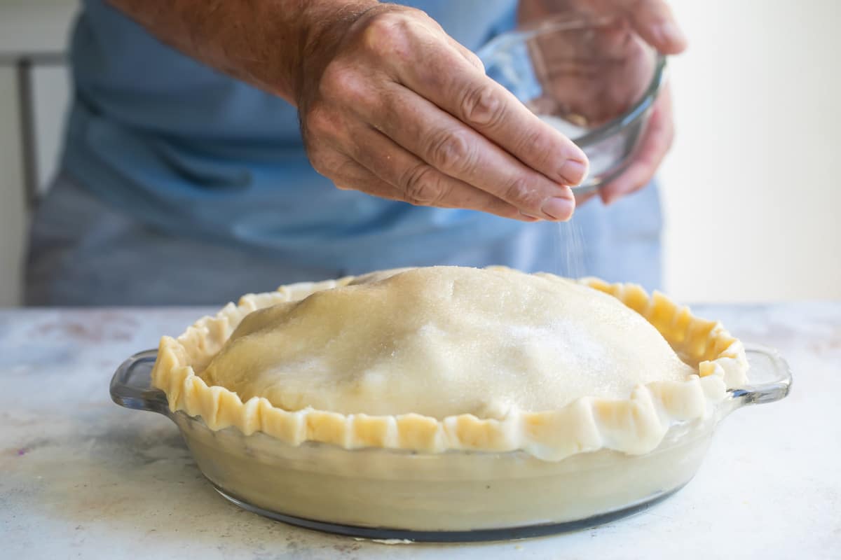 An unbaked, unsliced apple pie.