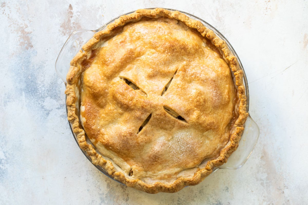 A baked, unsliced apple pie.