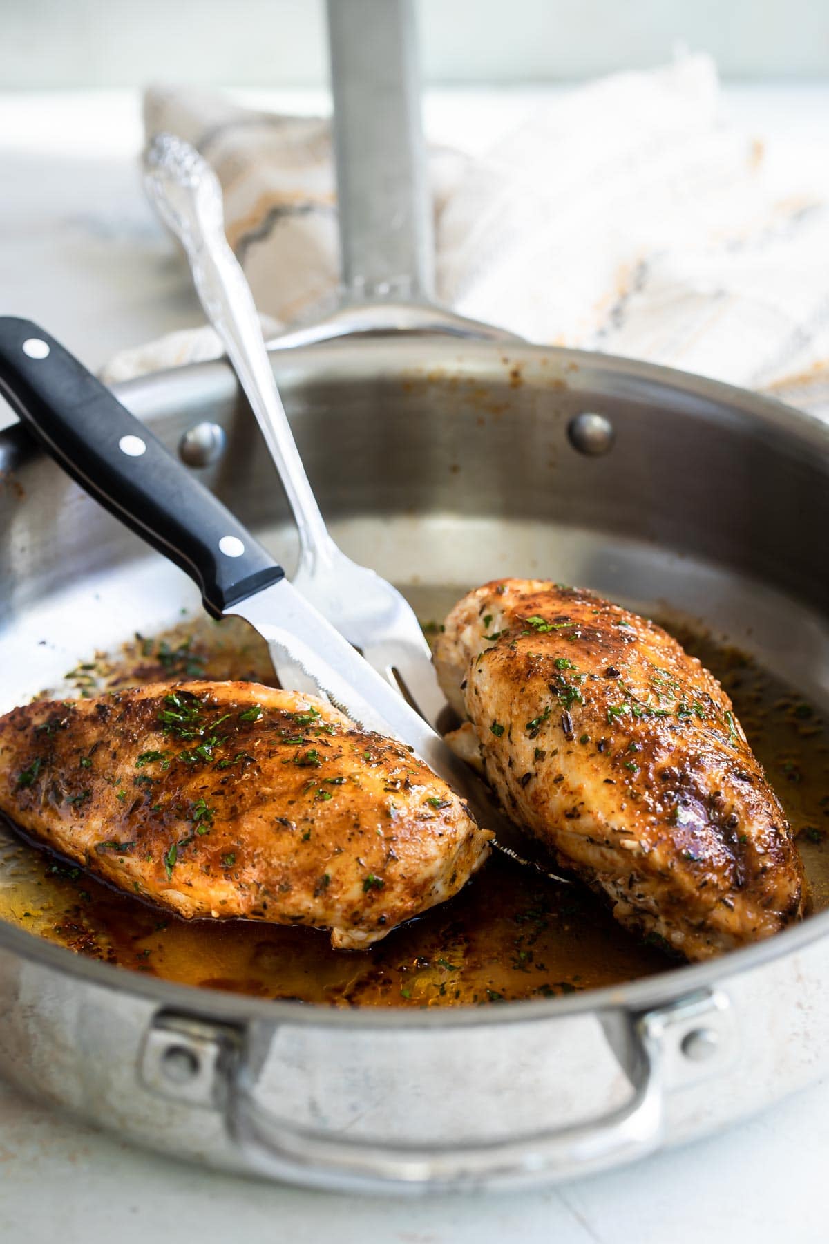 Blacked chicken in a skillet.