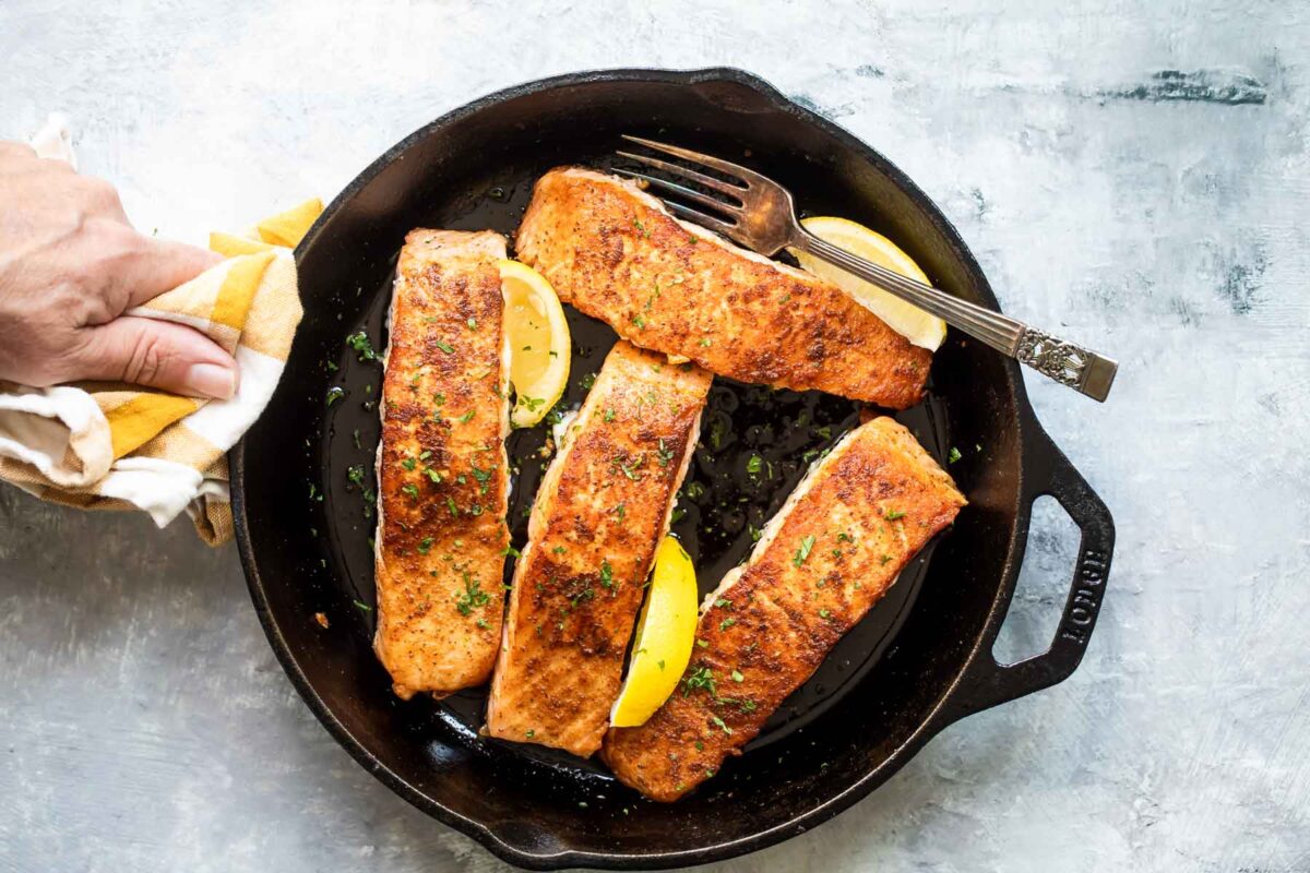 Salmon in a cast iron skillet.