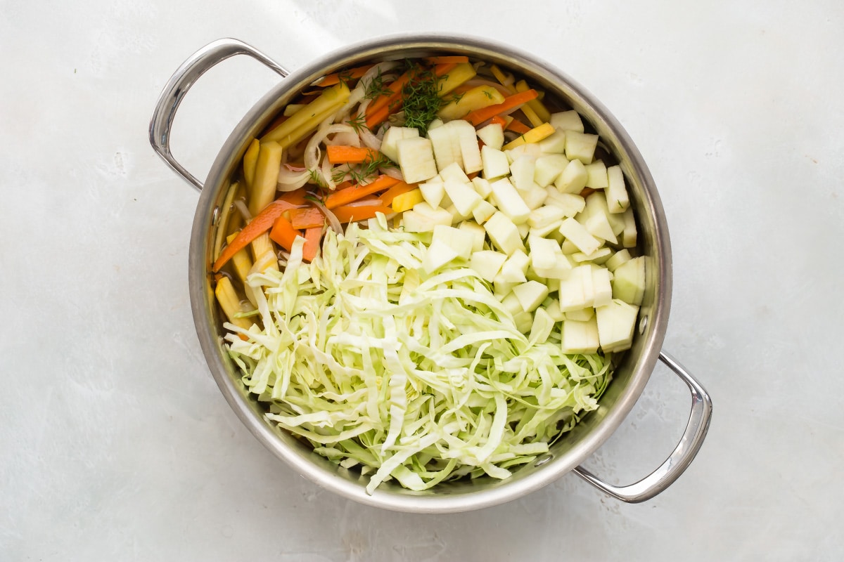 Vegetables cooking in a pan for cabbage soup.