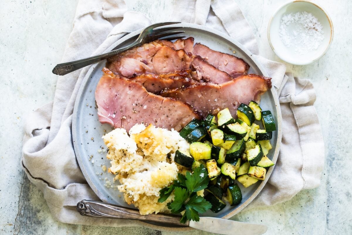 Dr. Pepper ham and vegetables on a plate.