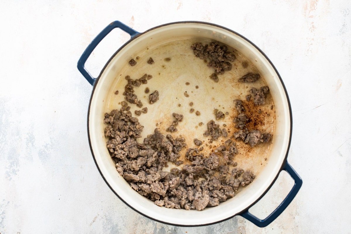 Ground pork in a Dutch oven.