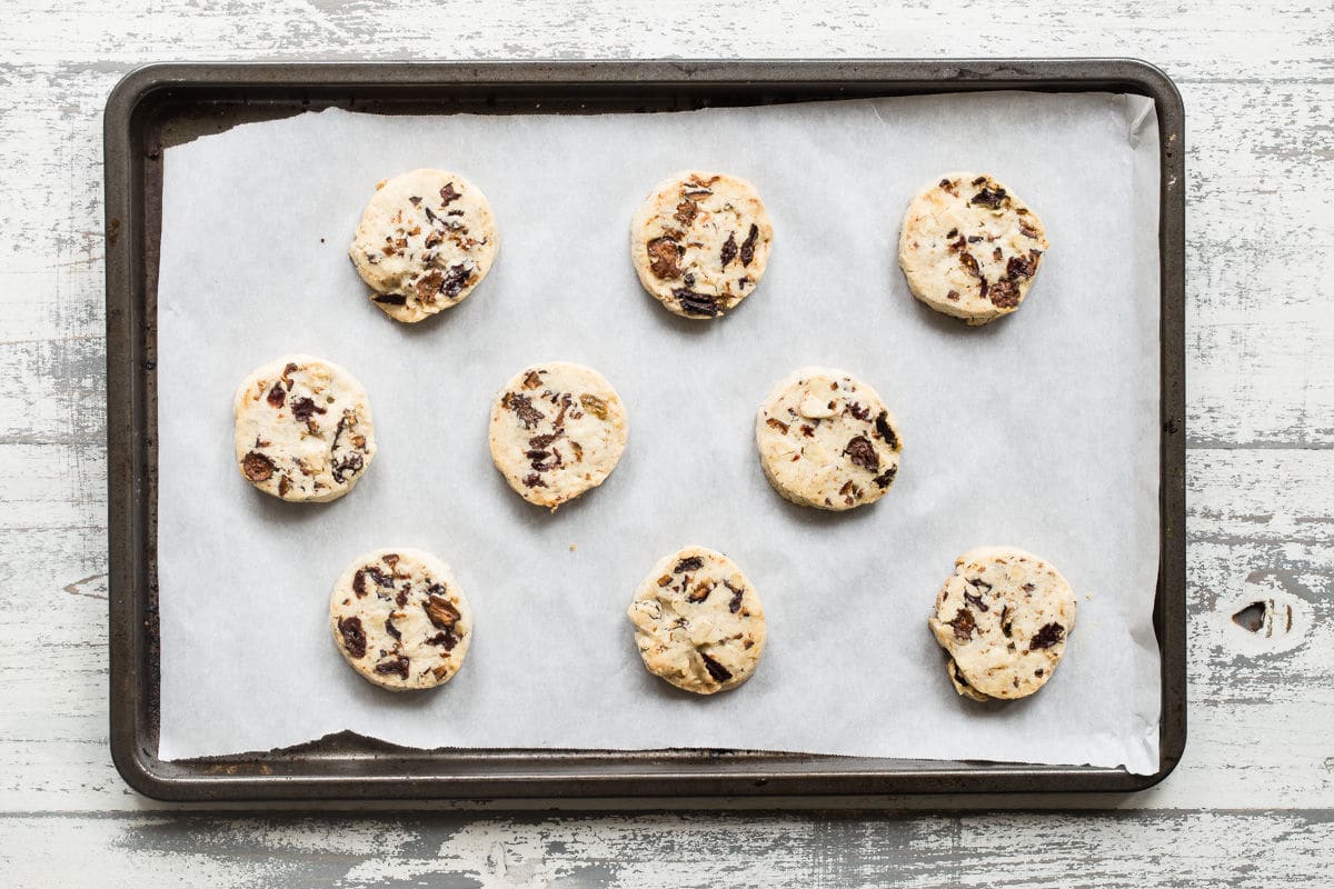 Fruitcake cookies baked on a baking sheet.