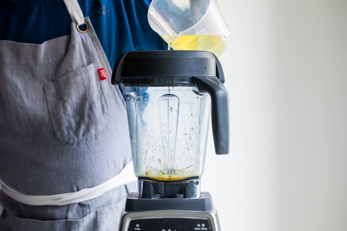 Oil being poured into a blender.