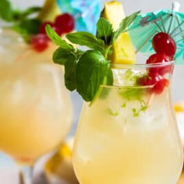 Two Mai Tai cocktails on a counter.