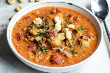 A white bowl filled with Manhattan clam chowder.
