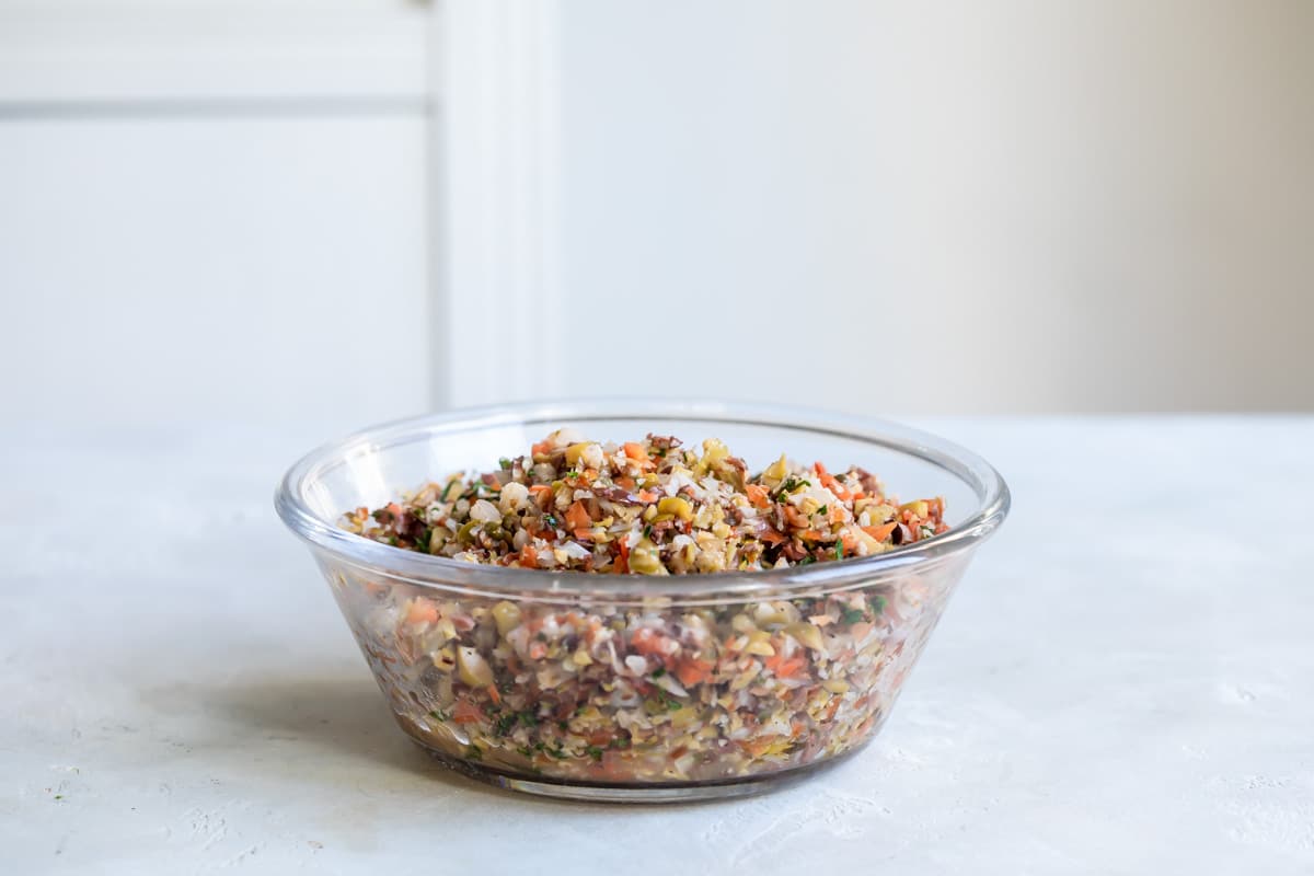 Muffaletta mixture in a clear bowl.