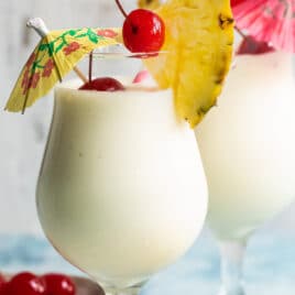 Two Piña Coladas on a counter.