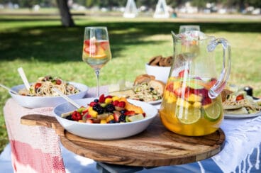 A set up of a picnic foods in a park.