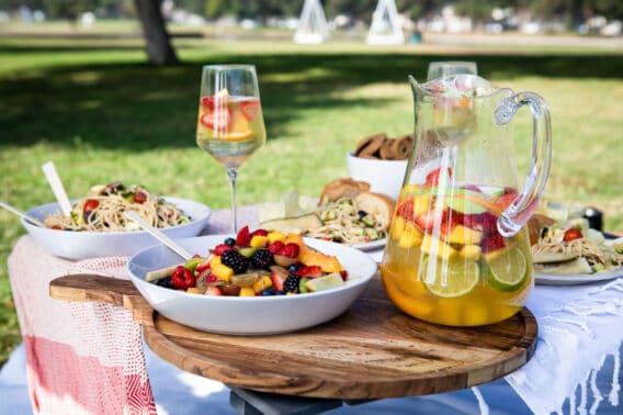 A set up of a picnic foods in a park.