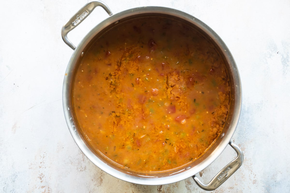 Shrimp etouffee being cooked in a silver pot.