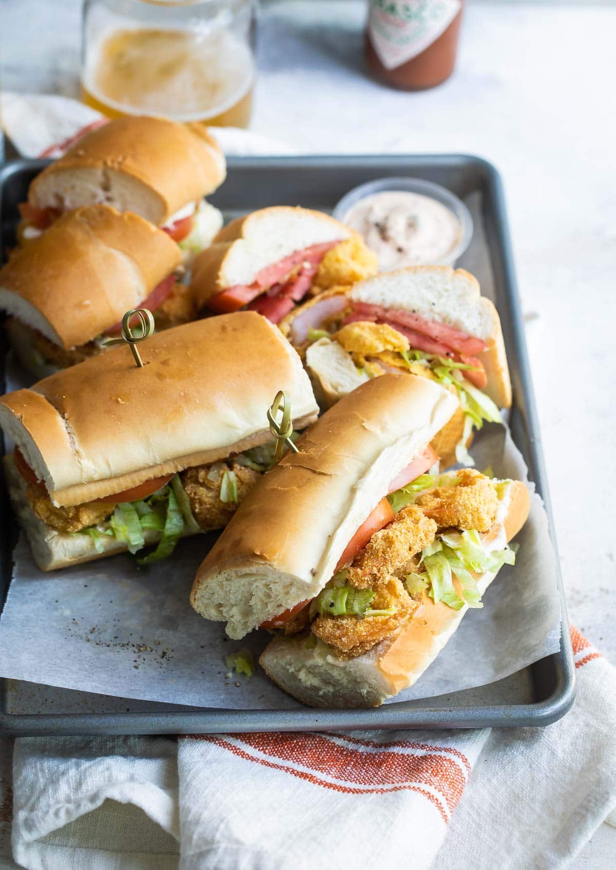 Shrimp po' boy on a metal serving platter.