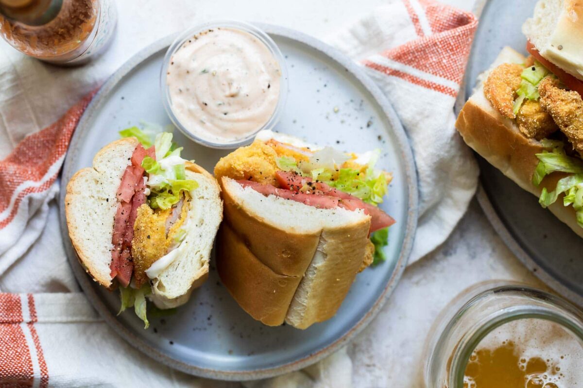 A Shrimp Po' Boy sandwich on a gray plate.