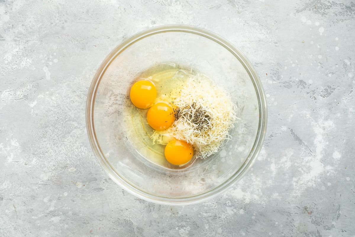 Eggs and cheese in a bowl for carbonara.