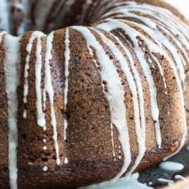 A round spice cake with drizzled icing.