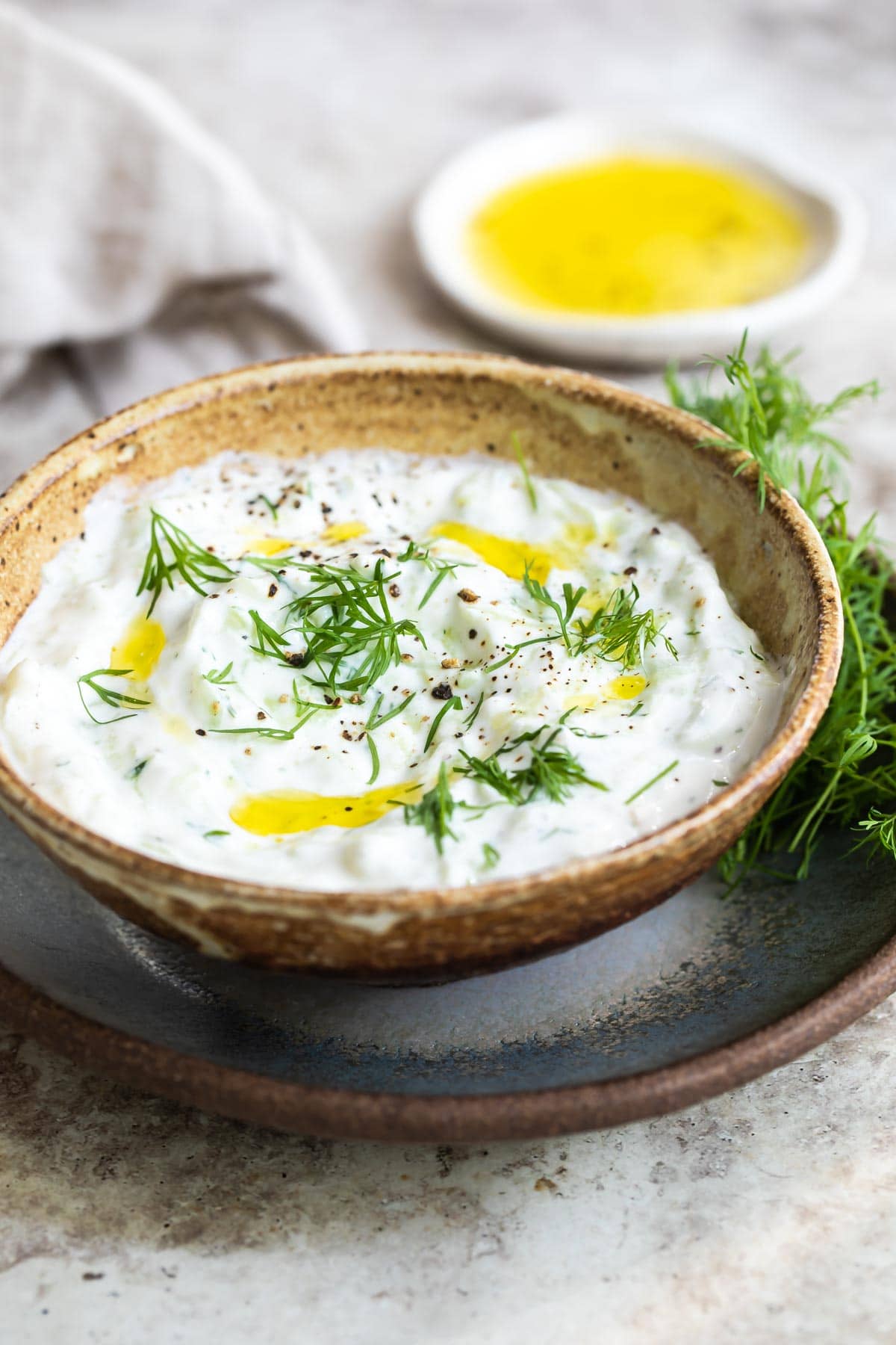 Tzatziki sauce on a brown bowl.
