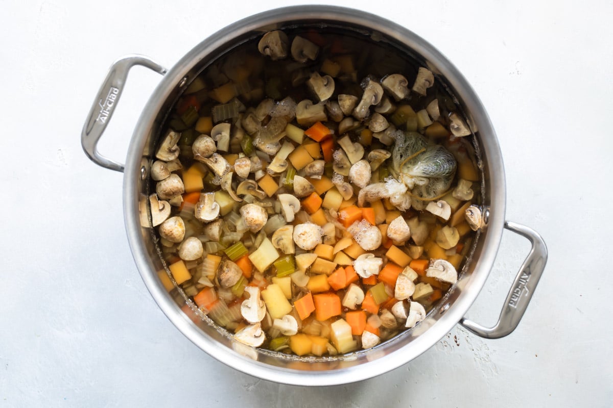 Vegetable stock being made in a Dutch oven.