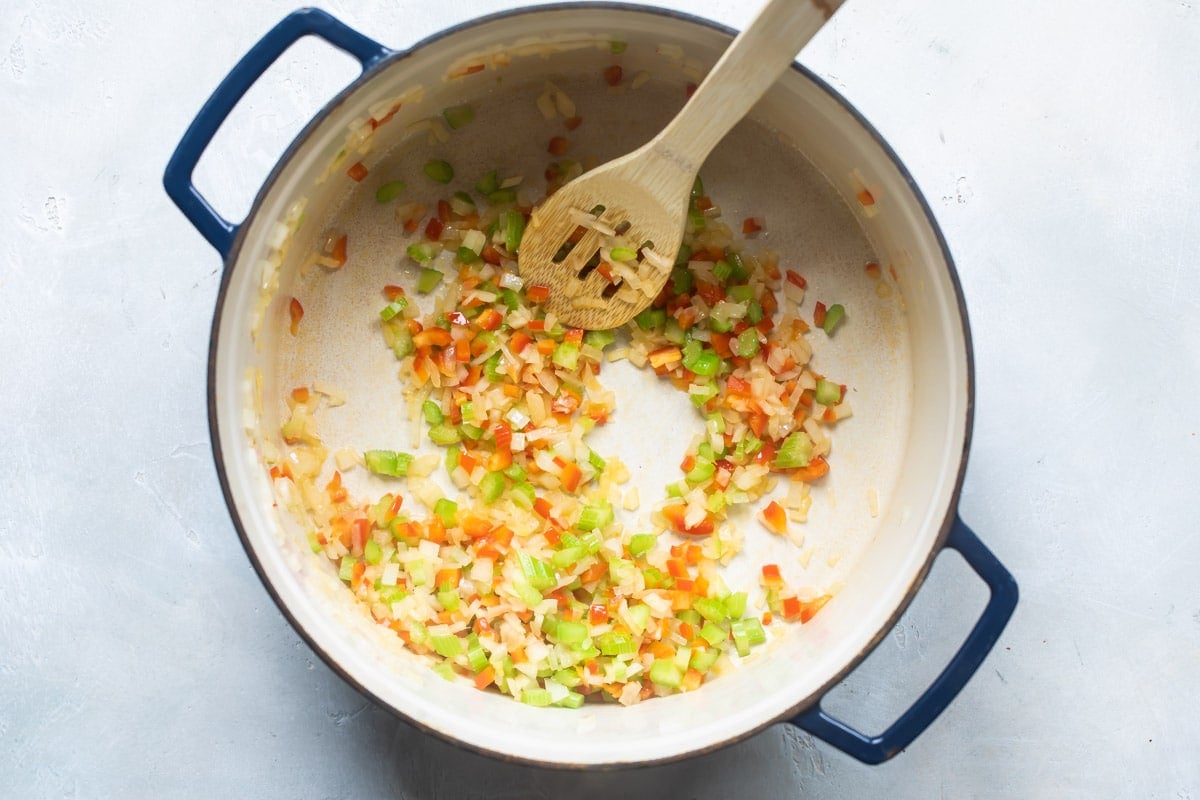 Vegetables being cooked in a Dutch oven.