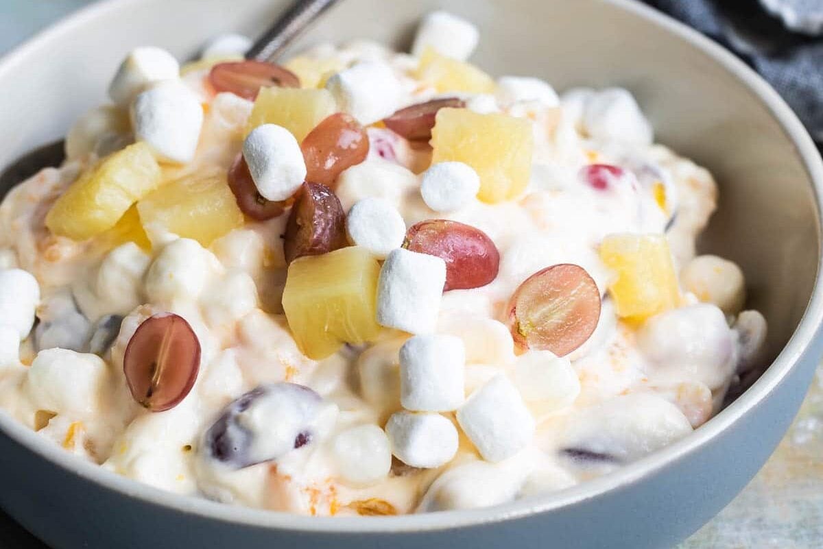 24 hour fruit salad in a blue serving bowl.