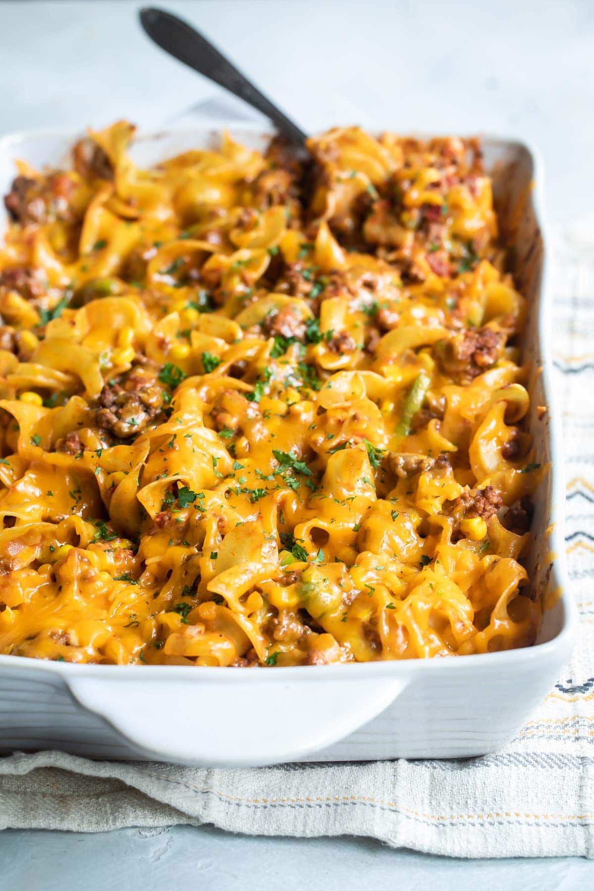 Beef noodle casserole in a white baking dish.