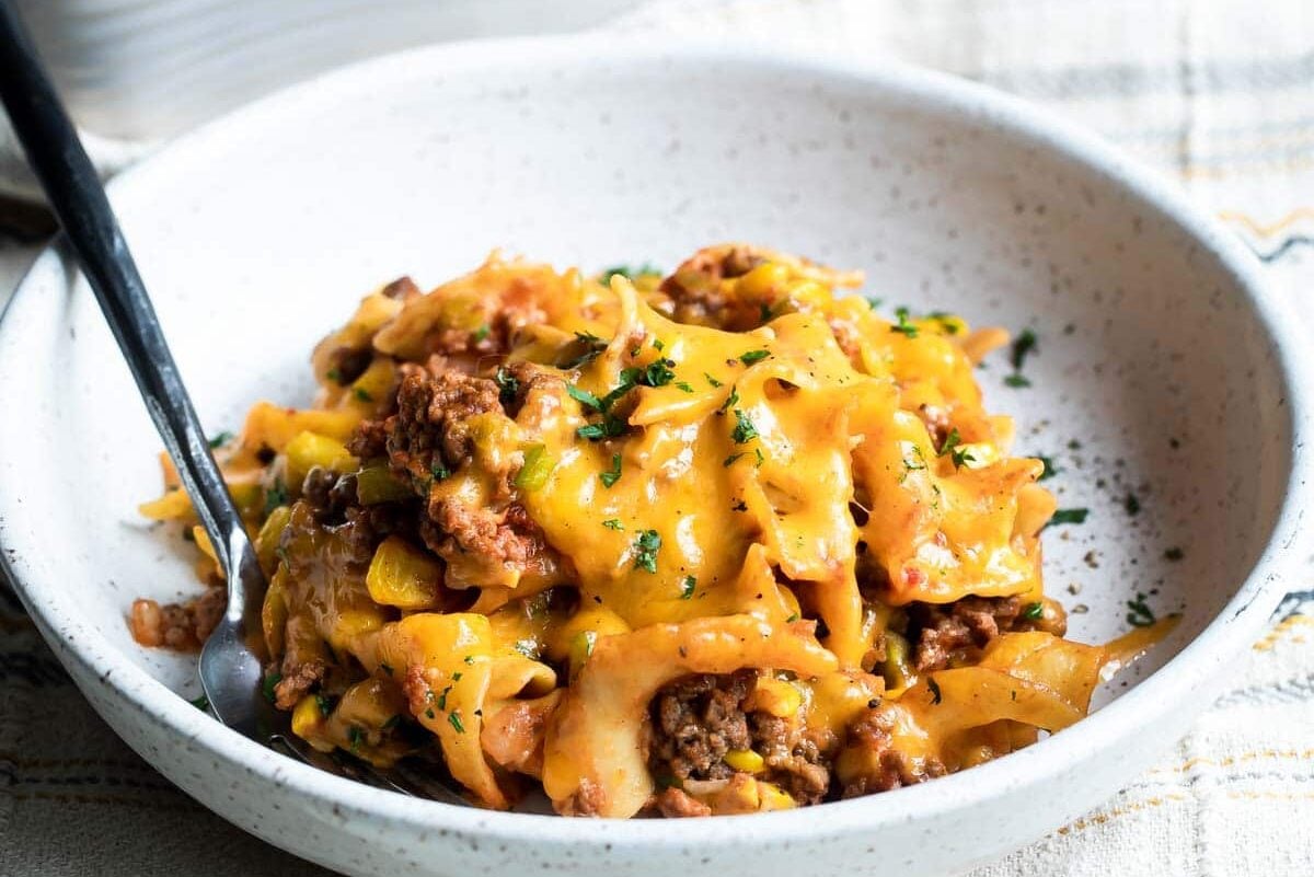 A serving of beef noodle casserole on a white plate.