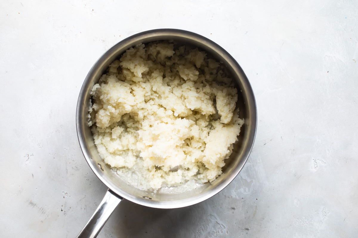 Cauliflower mash in a silver saucepan.