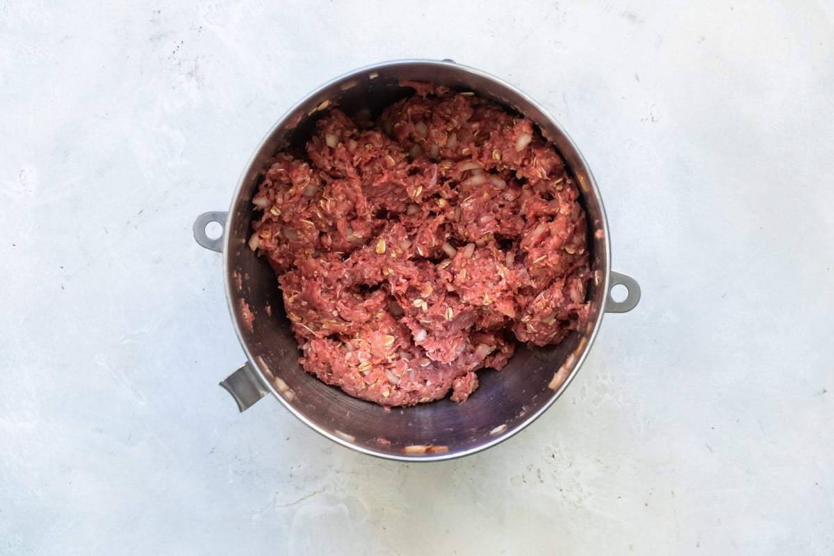 Meatloaf mixture in a silver bowl.